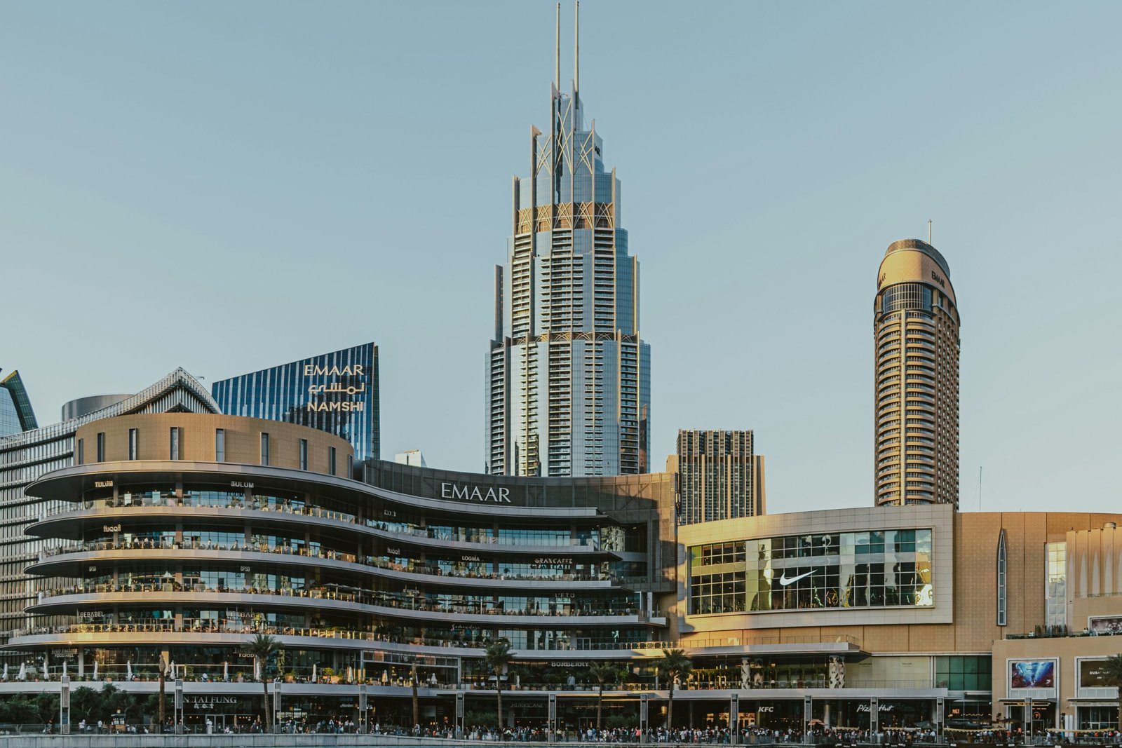 Downtown Dubai skyline featuring Emaar-developed towers and a large mixed-use retail complex at street level.