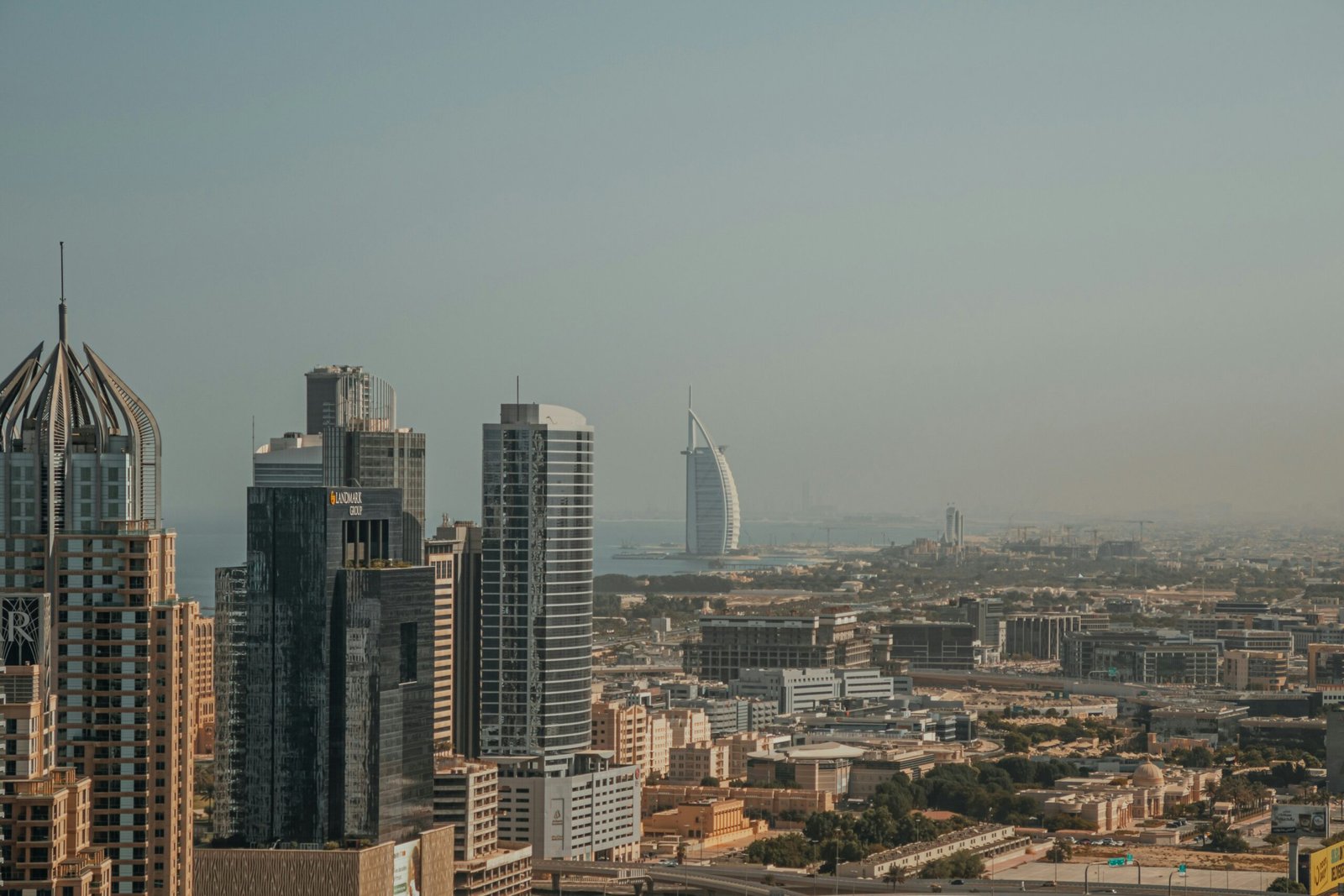 Panoramic view of Dubai’s skyline showing office towers, mixed-use buildings, and coastal landmarks extending toward the horizon.