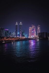 Leasehold vs Freehold Dubai – illuminated waterfront skyline at night highlighting prime ownership zones and property rights differences.