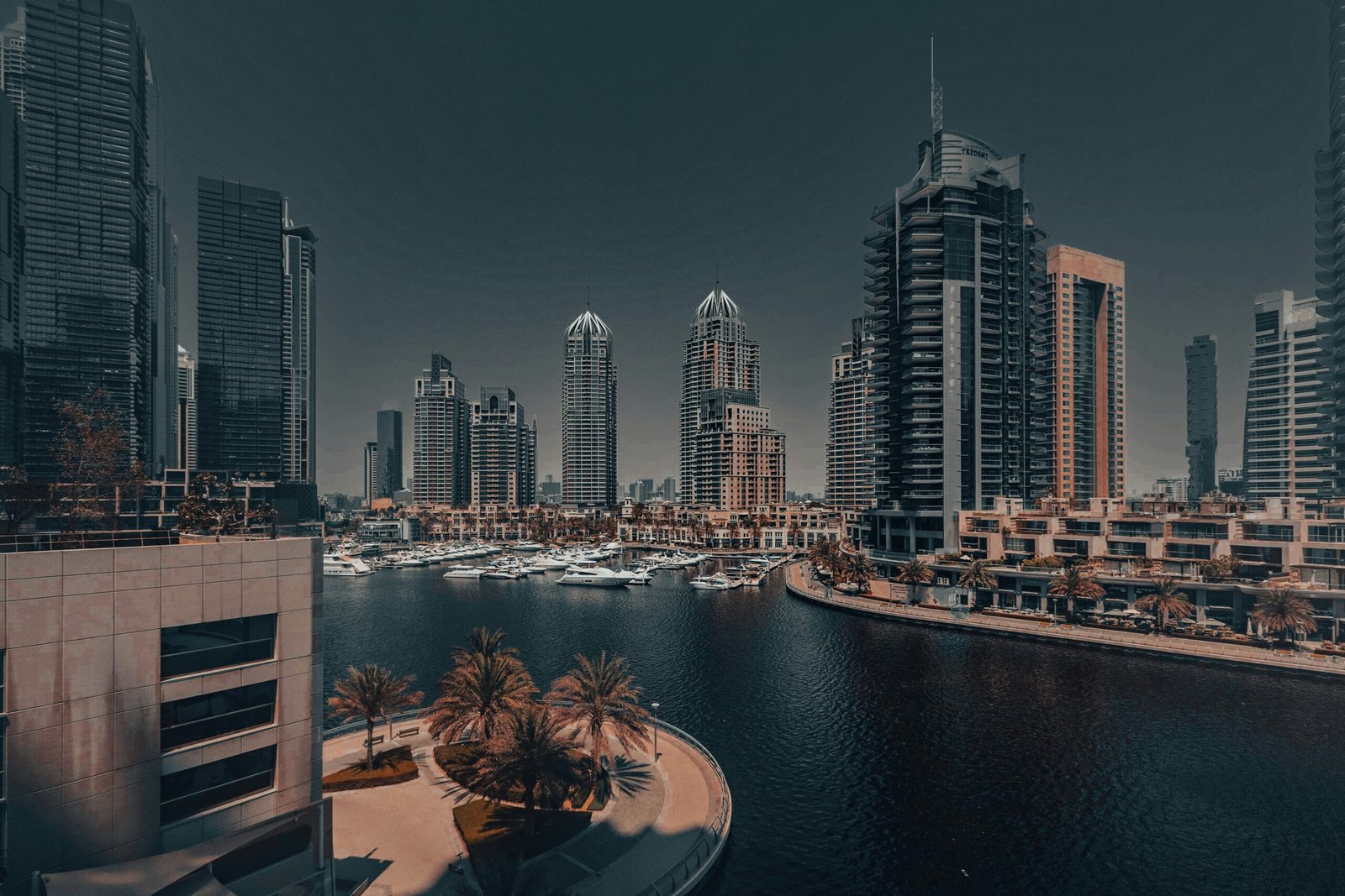 Cost to buy an apartment in Dubai – waterfront skyline of Dubai Marina with residential towers, yachts, and mixed-use developments.